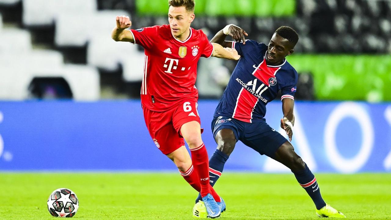 Das Foto zeigt Joshua Kimmich von Bayern München im Zweikampt gegen Idrissa Gueye von Paris Saint-Germain.