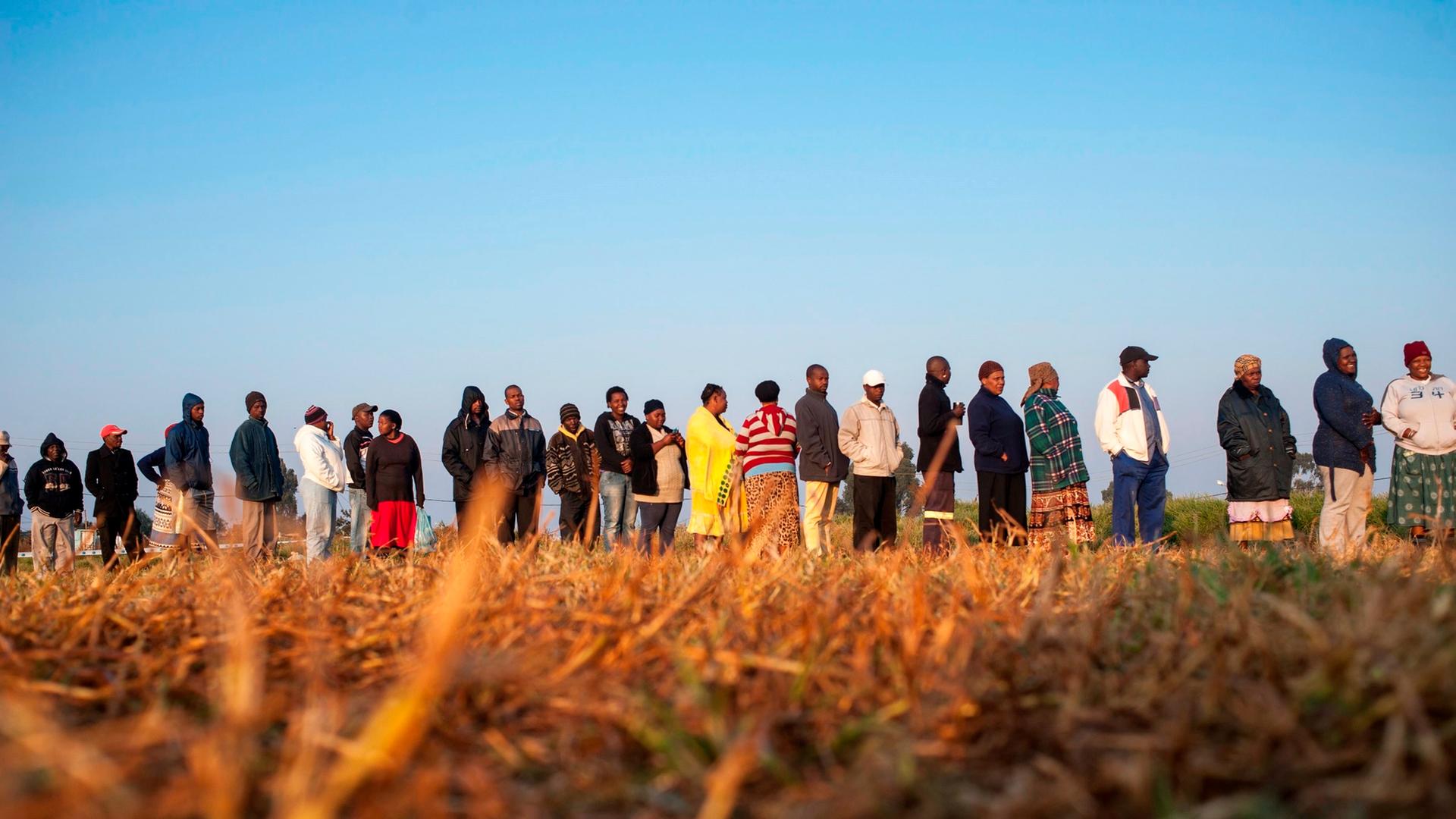 epa04194512 Some of the hundreds of people stand in line to cast their vote at a polling station at the Hospital Hill informal settlement south of Johannesburg, South Africa, early 07 May 2014. South Africans started voting in general elections expected t