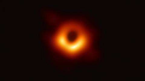 [DRAFT CAPTION] The Event Horizon Telescope (EHT) — a planet-scale array of eight ground-based radio telescopes forged through international collaboration — was designed to capture images of a black hole. In coordinated press conferences across the globe, EHT researchers revealed that they succeeded, unveiling the first direct visual evidence of a supermassive black hole and its shadow. The shadow of a black hole seen here is the closest we can come to an image of the black hole itself, a completely dark object from which light cannot escape. The black hole’s boundary — the event horizon from which the EHT takes its name — is around 2.5 times smaller than the shadow it casts and measures just under 40 billion km across.