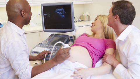 Schwangeres Paar bei der Ultraschalluntersuchung