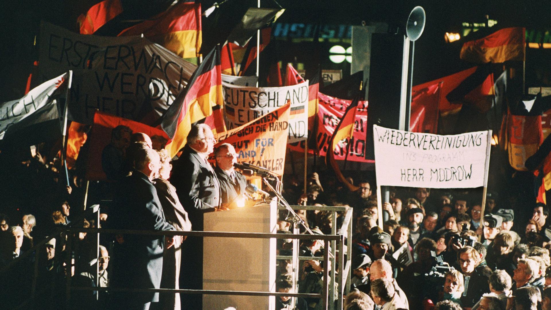 Bundeskanzler Helmut Kohl spricht am Abend des 19. Dezember 1989 zu der riesigen Menschenmenge, die sich anlässlich seines Besuches eingefunden hat. Kohl hielt sich zu einem zweitägigen Besuch in der sächsischen Stadt auf und wurde an beiden Tagen von der DDR-Bevölkerung stürmisch gefeiert.
