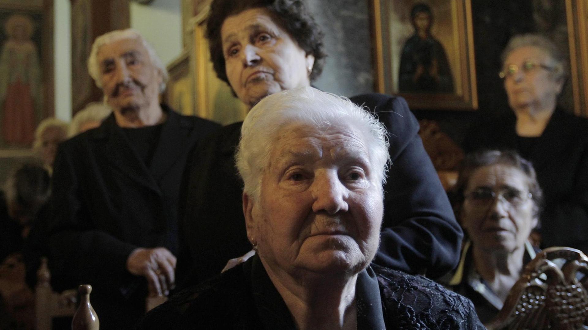 epa04800298 (05/18) Women, survivors of the Distomo massacre, attend a memorial service for the victims of the Distomo massacre during World War II, in Distomo, Greece, 10 June 2015. In Distomo, Nazi troops slaughtered 218 men, women and children in reprisal for acts of resistance on 10 June 1944. During WWII, Greece lost 10 percent of its population, almost one million people, of which 400,000 starved to death, according to statistics. Greece has never waived its claim for war reparations from Germany, while survivors of Nazi atrocities in Greek towns and villages are currently in court battles to claim compensation. EPA/ORESTIS PANAGIOTOU PLEASE REFER TO THIS ADVISORY NOTICE (epa04800291) FOR FULL PACKAGE TEXT |