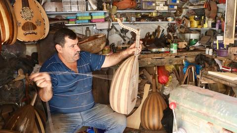 (180915) -- BAGHDAD, Sept. 15, 2018 -- Ali al-Abdali, an owner of a lute manufacturing workshop, makes lute in Rasheed Street in downtown Baghdad, Iraq on Aug. 26, 2018. TO GO WITH Feature: Lute manufacturing in Baghdad resists extinction )(axy) IRAQ-BAGHDAD-LUTE MAKING KhalilxDawood PUBLICATIONxNOTxINxCHN
