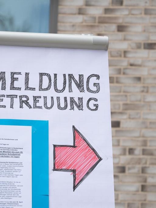 Ein Flipchart mit der Aufschrift «Anmeldung Notbetreuung» steht auf dem Gelände der Grundschule Hoheluft in Hamburg.