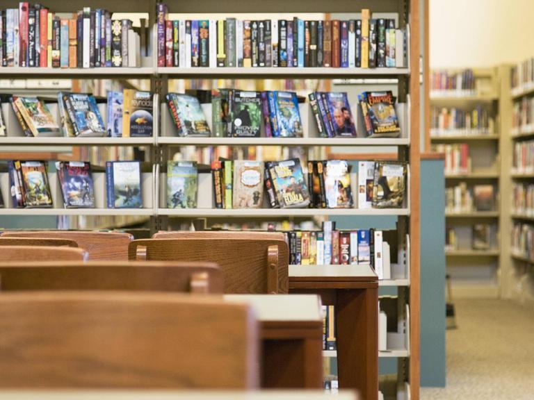 In einer Bibliothek in Washington stehen mehrere Bücherregale und Tische mit Stühlen.