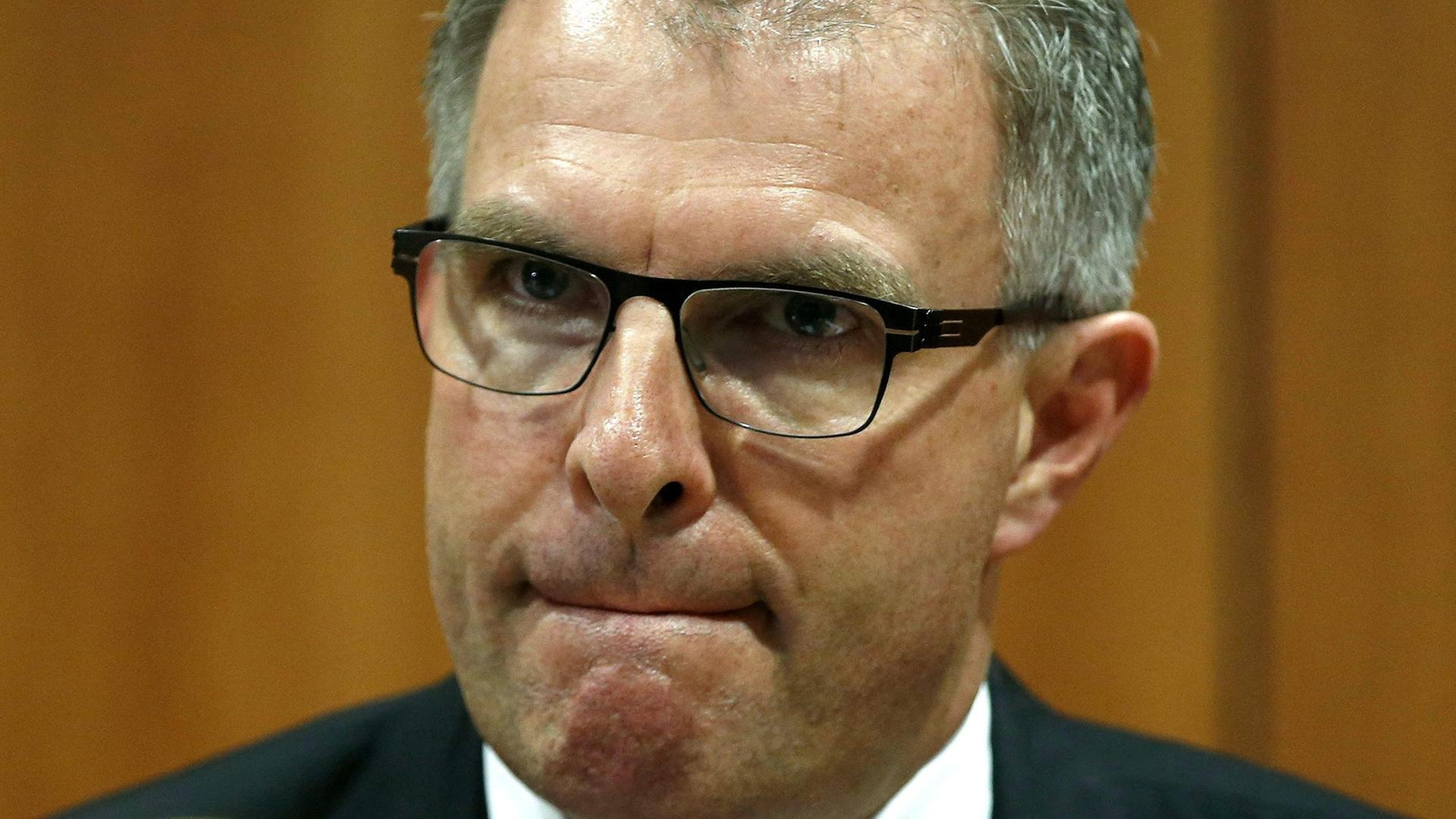 Lufthansa-Chef Carsten Spohr schaut in die Kamera. Er trägt eine Brille un presst die Lippen zusammen.