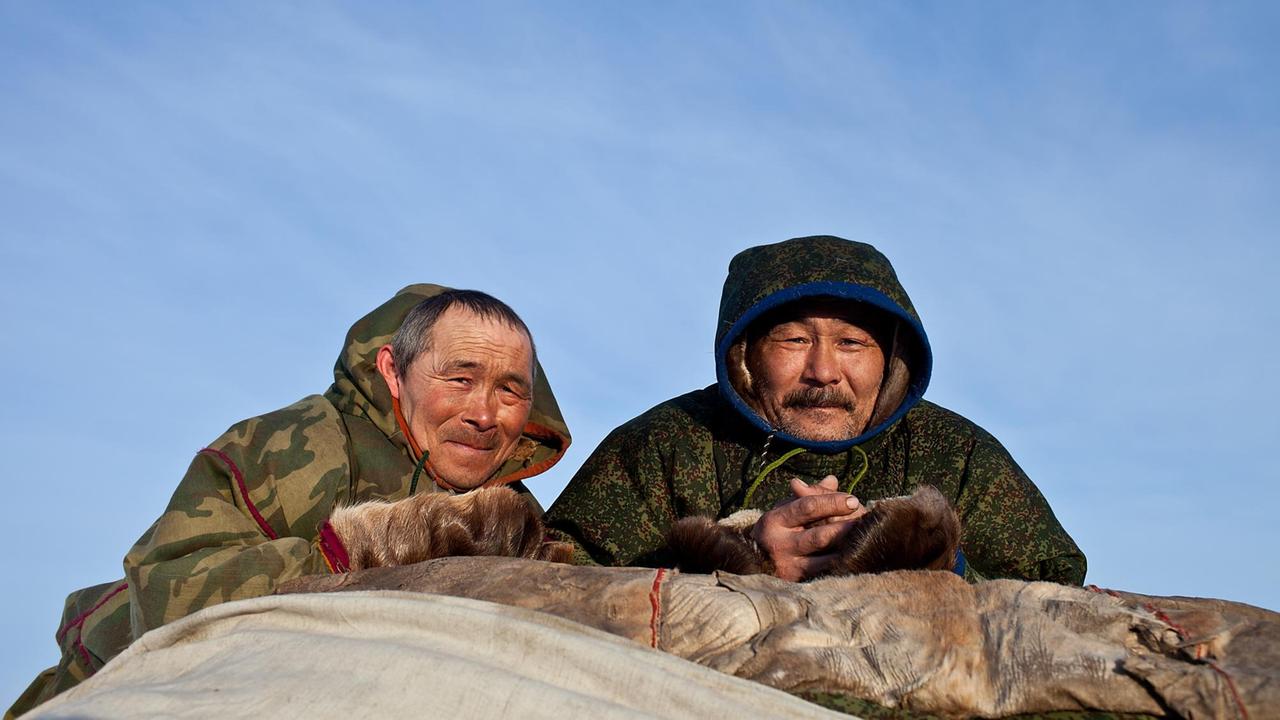 Jegor (links) und Mitja (rechts) beladen die Schlitten um zum nächsten Weideplatz für die Rentiere aufzubrechen
