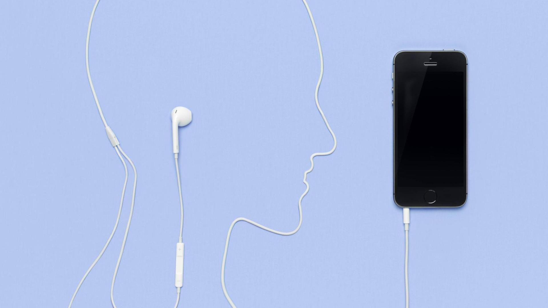 Kopfhörerkabel liegt in der Form eines Männerkopfes und ist in einem iPhone 5s eingestöpselt