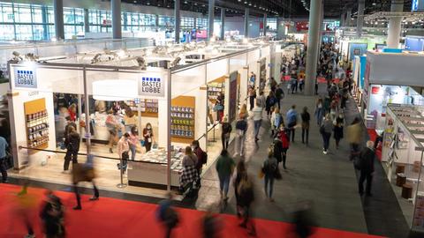 Menschen schlendern während des ersten Besuchertags der Frankfurter Buchmesse 2021 durch Halle 3