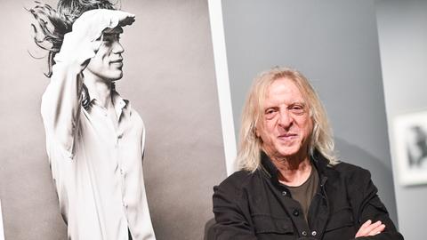 Der Fotograf Norman Seeff in den Reiss-Engelhorn-Museen in der Fotoausstellung "The Look of Sound" neben einem Foto von Mick Jagger aus dem Jahr 1972.