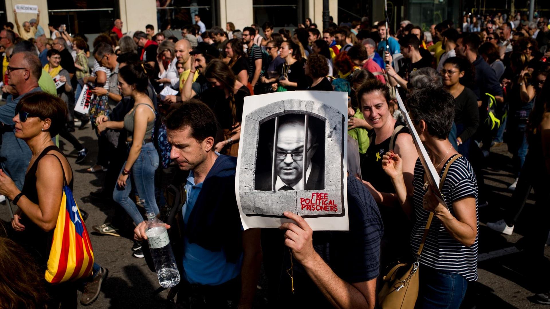 Demonstrantinnen und Demonstranten zeigen Fotos der Verurteilten.