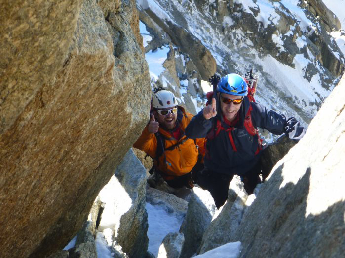 Zwei Bergsteiger klettern an einem Felsen.