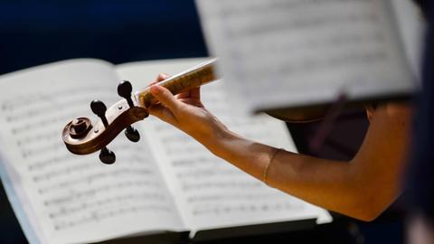 Violinisten spielen in einem Orchester bei einem Konzert.