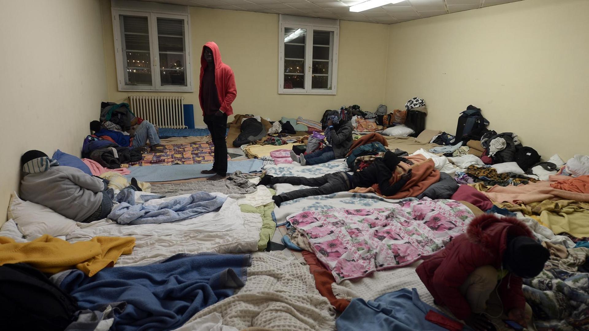 Migranten kommen in Bayonne in einem Matratzenlager unter