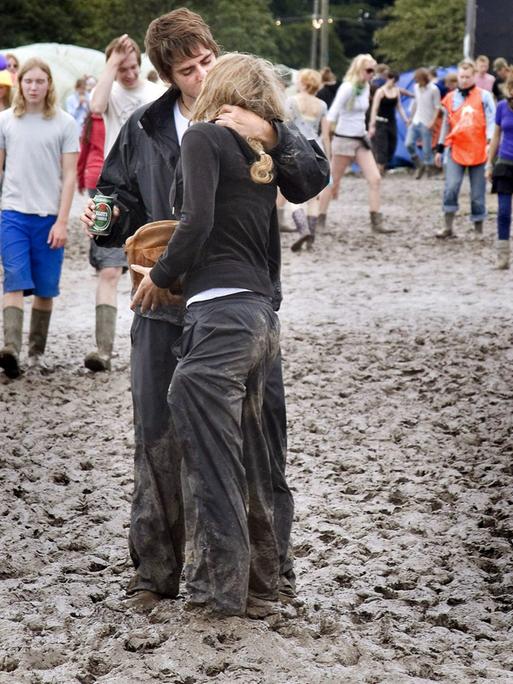 Picture made available on 04 July 2007 shows unidentified youths standing in mud in the camping area of the Roskilde Festival, some 30 kilometres west of Copenhagen, Denmark