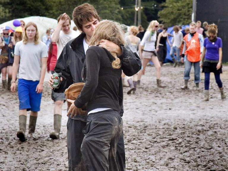 Picture made available on 04 July 2007 shows unidentified youths standing in mud in the camping area of the Roskilde Festival, some 30 kilometres west of Copenhagen, Denmark