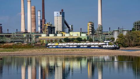 Extremes Niedrigwasser auf dem Rhein führt zur Bildung von Sandbänken. Der Frachter im kann nur mit reduzierter Ladung fahren. Im Hintergrund das Thyssenkrupp Steel Stahlwerk in Duisburg-Marxloh.