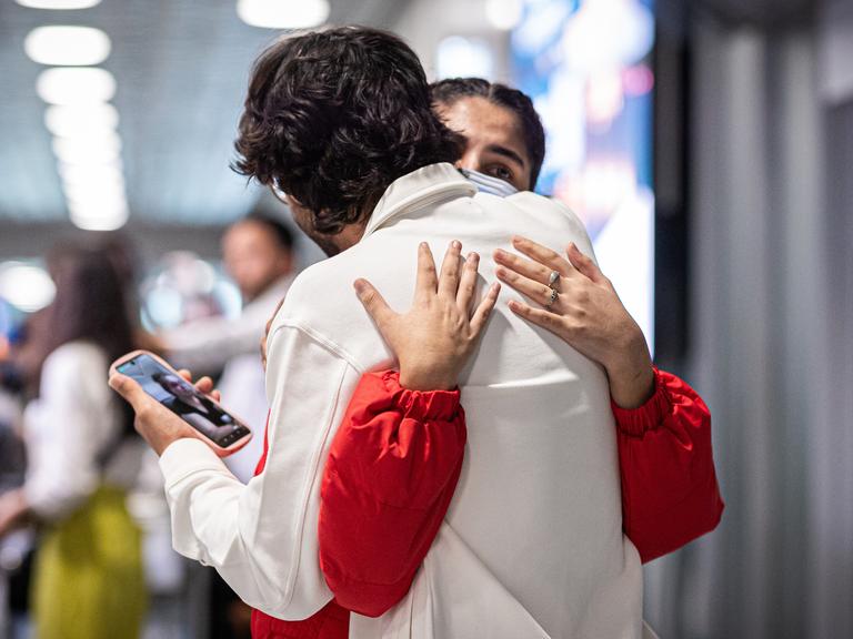 Menschen aus Afghanistan, die zuvor mit einem Flugzeug auf dem Flughafen Hannover-Langenhagen gelandet sind, umarmen sich. Menschen aus Afghanistan, die zuvor mit einem Flugzeug auf dem Flughafen Hannover-Langenhagen gelandet sind, umarmen sich.