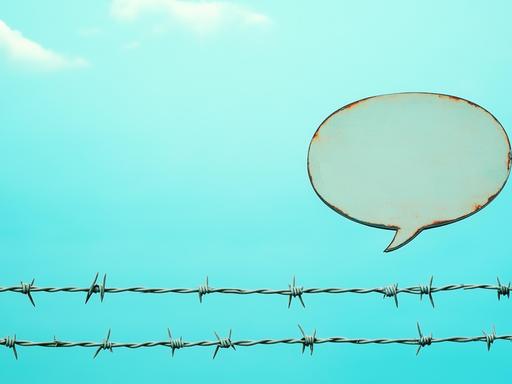 Sprechblase über Stacheldraht