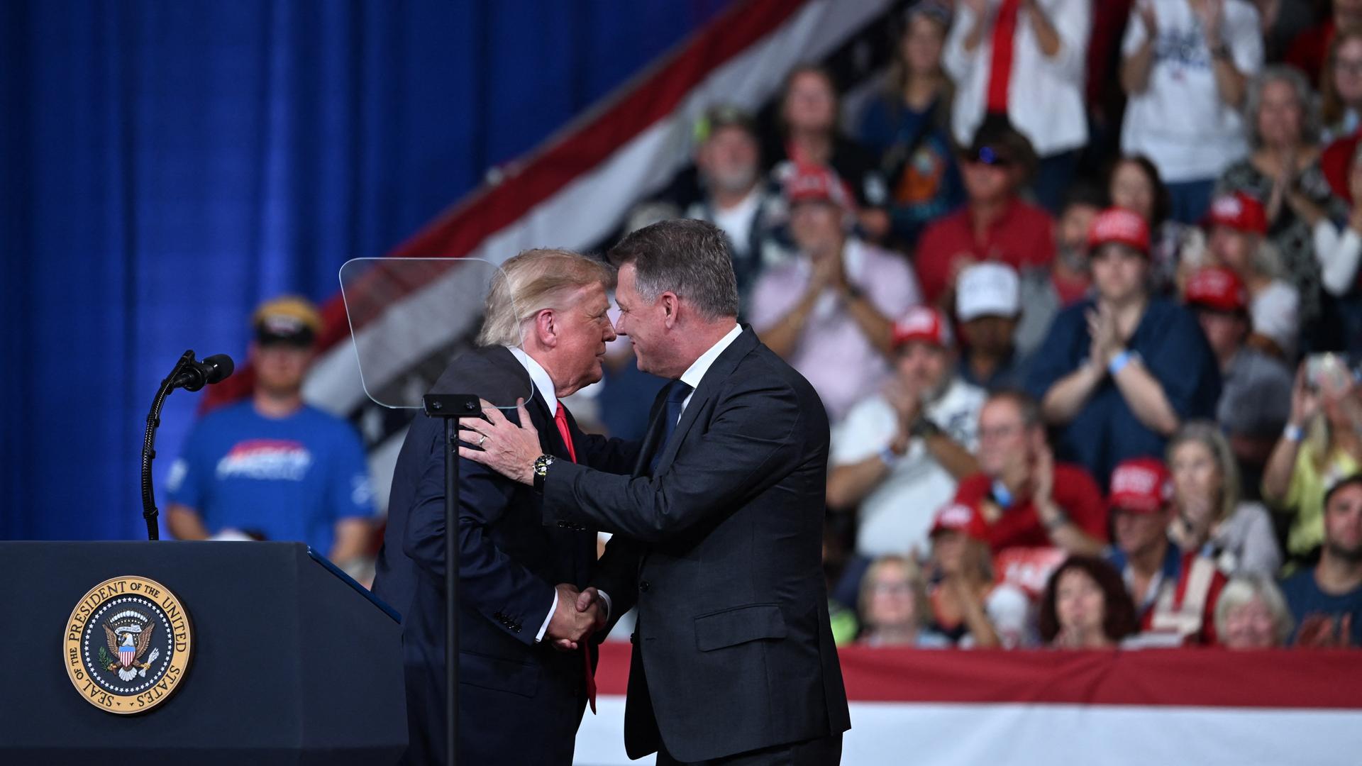 US-Präsident Donald Trump begrüßt den Vorstandsvorsitzenden der Audi AG, Gernot Döllner, bei einer Wahlkampfveranstaltung im Vorfeld der Zwischenwahlen im Guardian Centers of Georgia in Perry, Georgia, am 24. Oktober 2026. US-Präsident Donald Trump begrüßt den Vorstandsvorsitzenden der Audi AG, Gernot Döllner, bei einer Wahlkampfveranstaltung im Vorfeld der Zwischenwahlen im Guardian Centers of Georgia in Perry, Georgia, am 24. Oktober 2026.