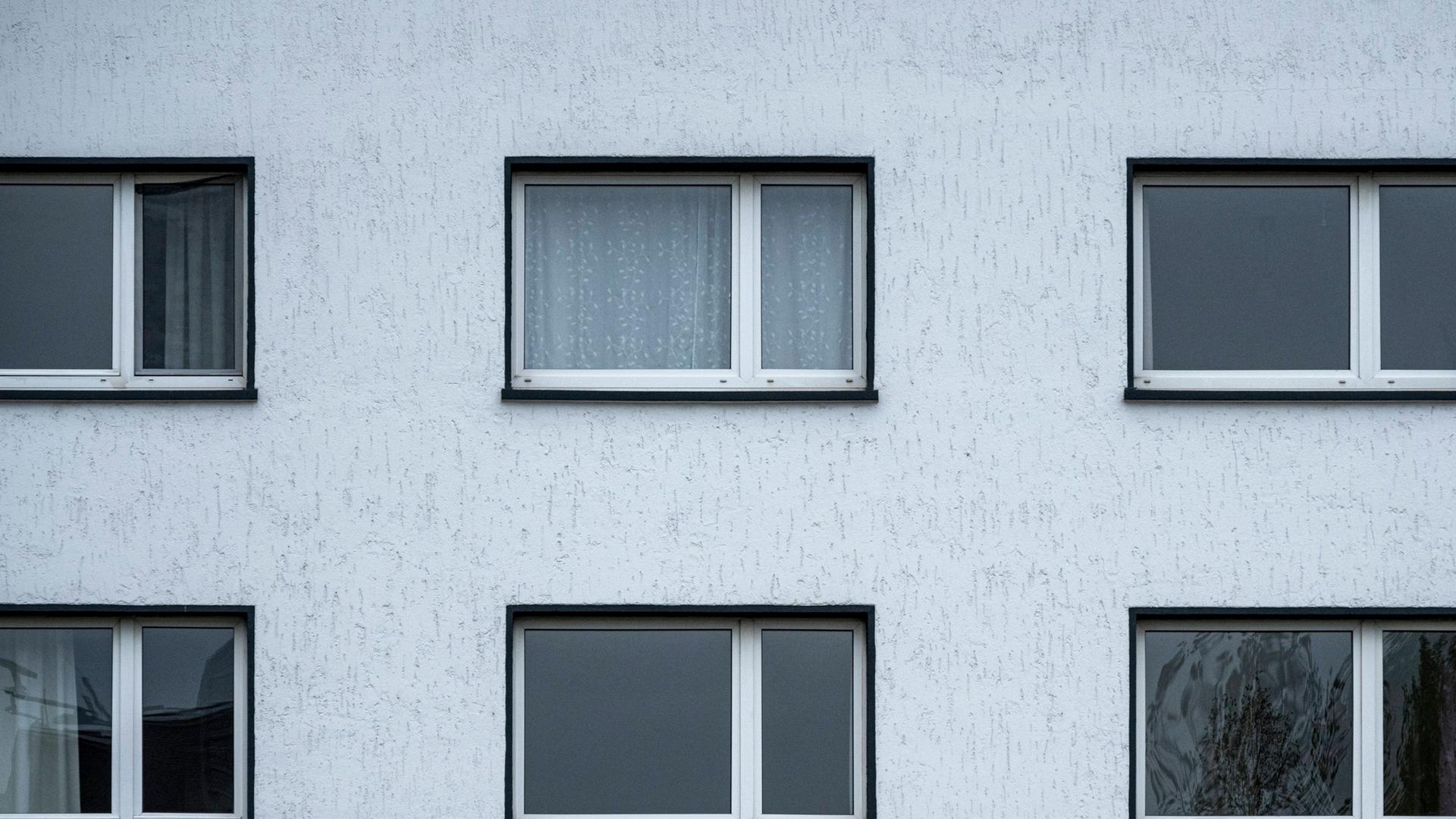 Die Fassade eines Wohngebäudes mit mehreren Fenstern Die Fassade eines Wohngebäudes mit mehreren Fenstern