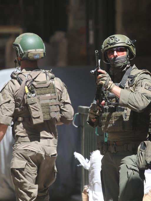 Drei israelische Soldaten patrouillieren auf einem Markt in der Altstadt von Nablus im nördlichen besetzten Westjordanland. Ein Soldat (r.) hält seine Waffe am Anschlag (23.06.2026) Drei israelische Soldaten patrouillieren auf einem Markt in der Altstadt von Nablus im nördlichen besetzten Westjordanland. Ein Soldat (r.) hält seine Waffe am Anschlag (23.06.2026)