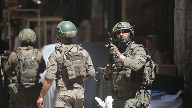 Drei israelische Soldaten patrouillieren auf einem Markt in der Altstadt von Nablus im nördlichen besetzten Westjordanland. Ein Soldat (r.) hält seine Waffe am Anschlag (23.06.2026)