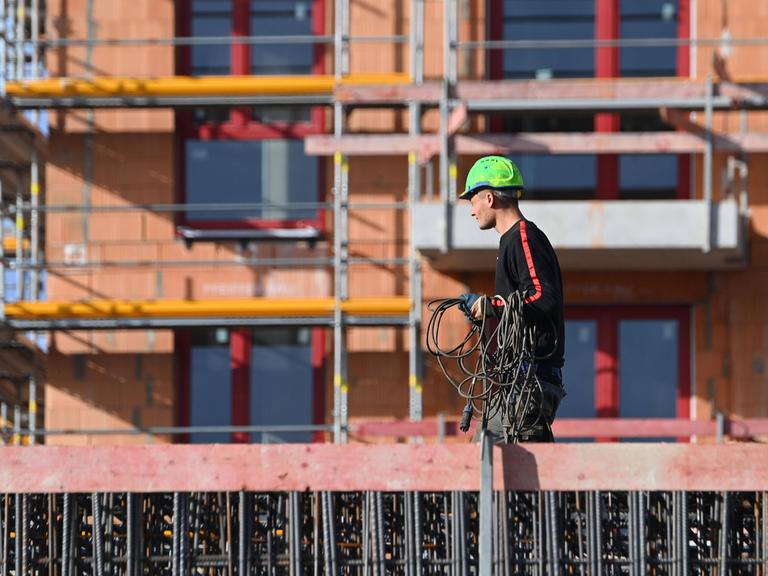 Bauarbeiter auf einer Großbaustelle eines Mehrfamilienhauses