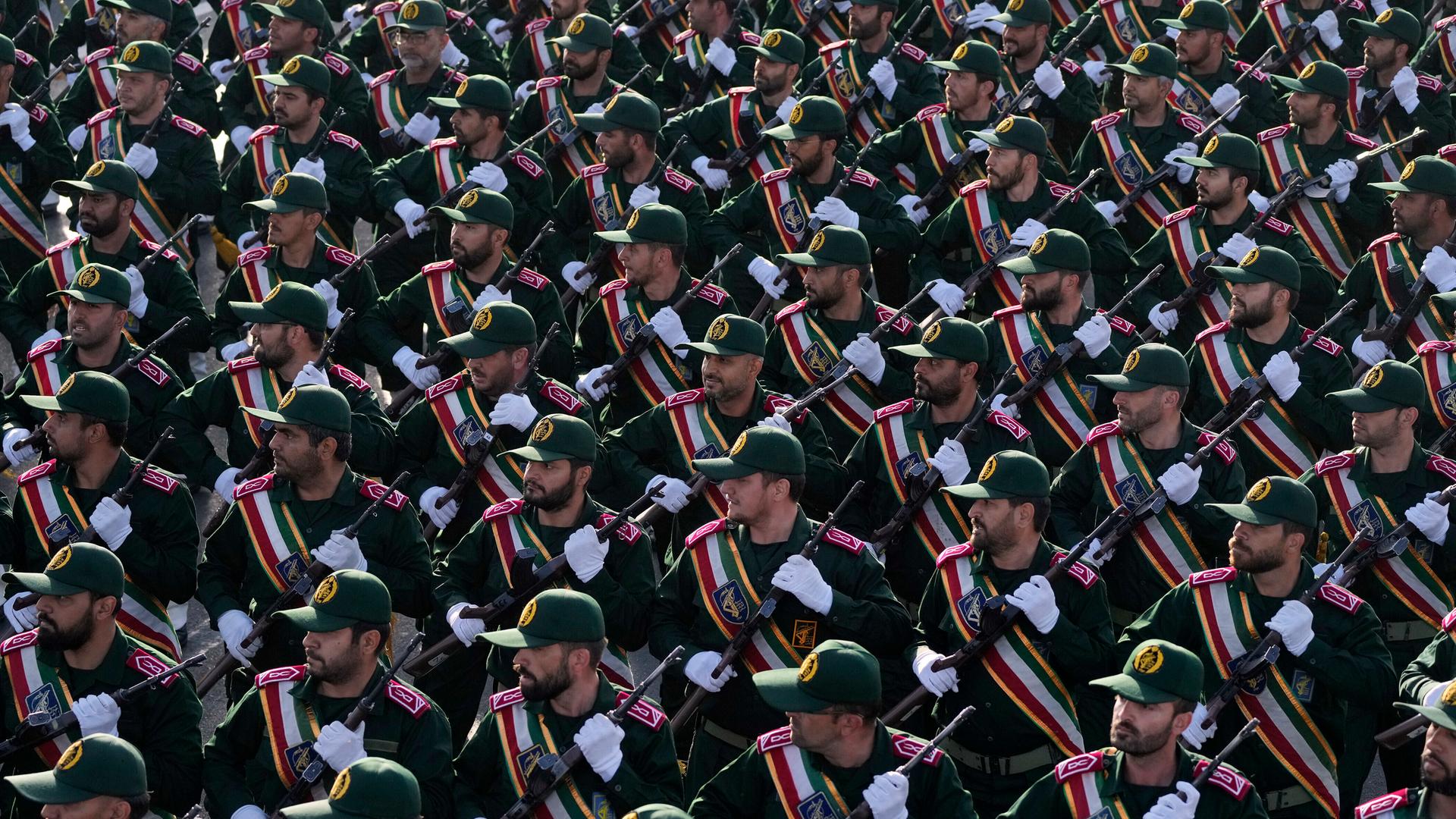 Soldaten der iranischen Revolutionsgarden marschieren durch Teheran bei einer Parade. Die Soldaten blicken alle nach rechts, sie tragen eine Waffe. Soldaten der iranischen Revolutionsgarden marschieren durch Teheran bei einer Parade. Die Soldaten blicken alle nach rechts, sie tragen eine Waffe.