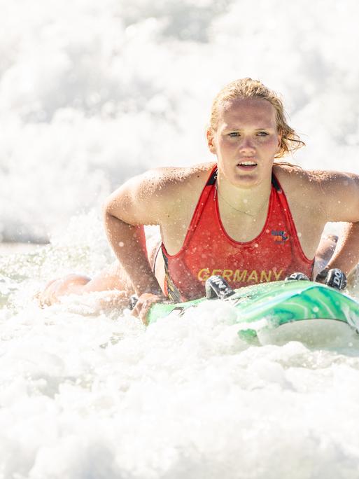 Die Sportlerin Lea Kötter bei der WM der Rettungsschwimmer 2024 in Australien. Lea Kötter liegt auf einem Rettungsbrett im Meer und bewegt sich in den Wellen.