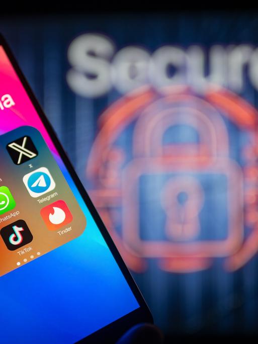 Social-Media-Symbole werden auf einem Smartphone angezeigt, im Hintergrund ist ein Sicherheitsschloss zu sehen.