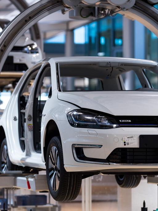 Ein VW e-Golf hängt an einer elektrischen Hängebahn in der Gläsernen VW-Manufaktur