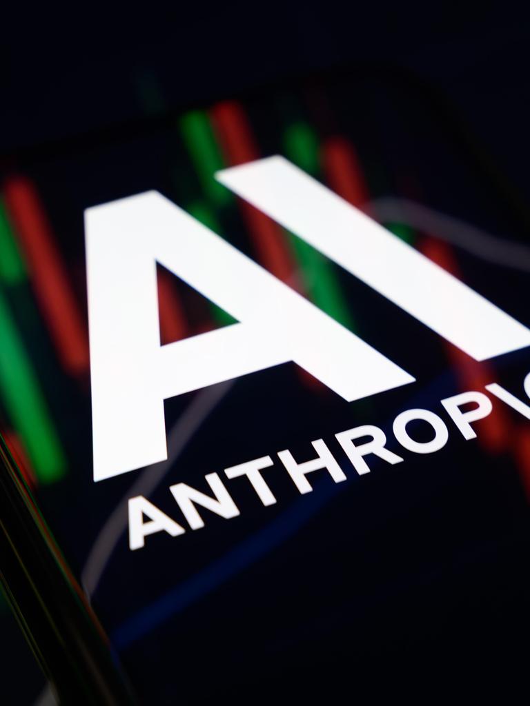Das Anthropic-Logo vor Börsencharts