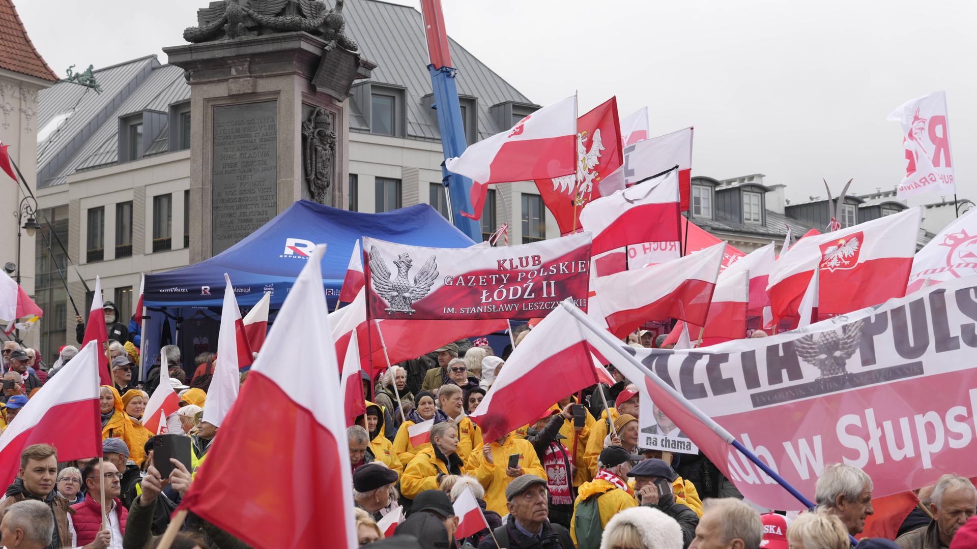 Demonstranten auf dem Schlossplatz in Warschau. Sie schwenken Fahnen. Demonstranten auf dem Schlossplatz in Warschau. Sie schwenken Fahnen.