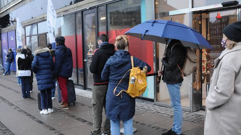 In Kopenhagen stehen Menschen am 30. Dezember in einer Einkaufspassage in einer Schlange, um in einem Testzentrum einen Corona-Schnelltest machen zu lassen.