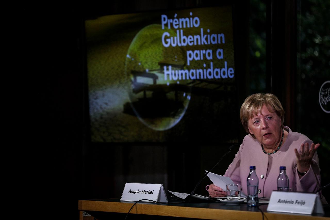 Altbundeskanzlerin Angela Merkel bei einer Veranstaltung der Stiftung Calouste Gulbenkian in der portugiesischen Hauptstadt Lissabon. Sie sitzt hinter einem Mikrofon.