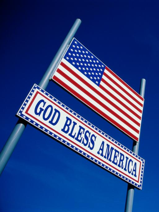 Eine US-amerikanische Flagge und der Spruch "God Bless America" vor 