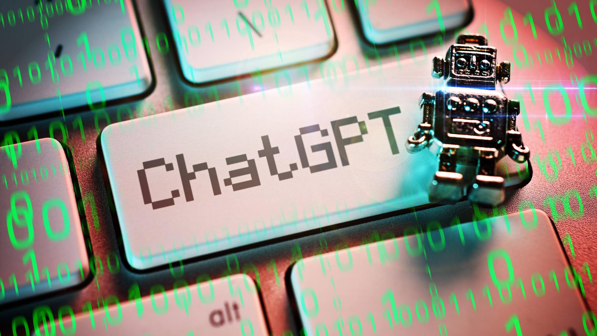 Eine Fotomontage von einem Miniatur-Roboter auf einer Computertaste mit der Aufschrift ChatGPT.