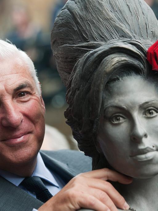 Mitch Winehouse posiert 2014, drei Jahre Amy Winehouse´ Tod, für ein Foto neben einer Statue seiner Tochter. 