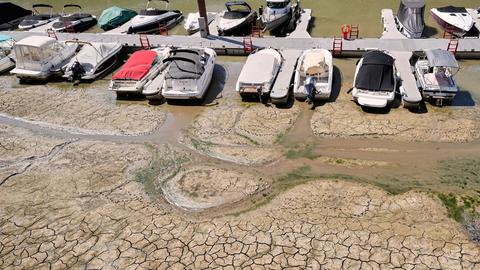 Kleine Boote liegen nebeneinander an einem Steg auf dem Trockenen im Kölner Rheinauhafen