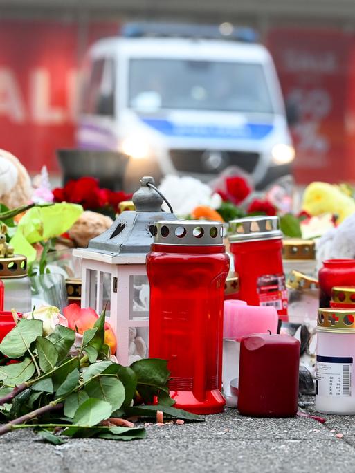 Plüschtiere, Kerzen und Blumen liegen am zentralen Gedenkort für die Opfer des Anschlags vor der Johanniskirche in Magdeburg. 