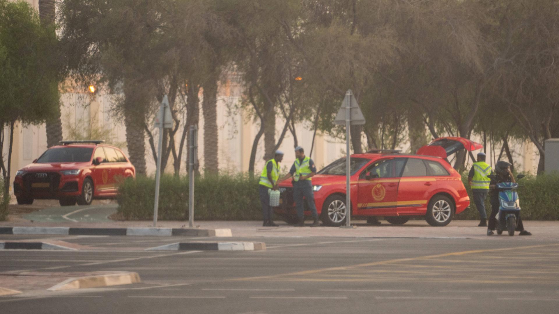 Sicherheitspersonal mit zwei roten Autos stehen in der Nähe des Anschlags in Doha. Sicherheitspersonal mit zwei roten Autos stehen in der Nähe des Anschlags in Doha.