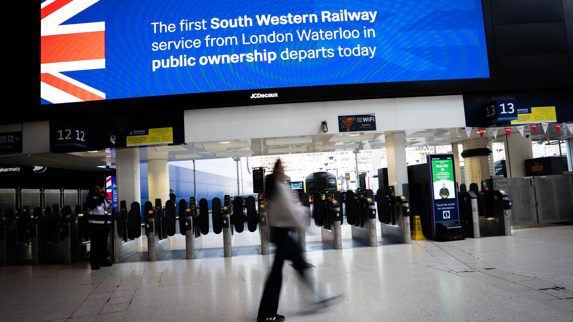 Eine Leuchtreklametafel wirbt damit, dass heute der erste "South Western Railway"-Zug im staatlichen Besitz vom Bahnhof London Waterloo Station abfährt.