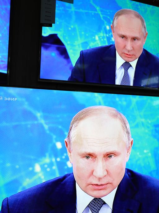 Das Gesicht Wladimir Putins vierfach auf einem Bildschirm.