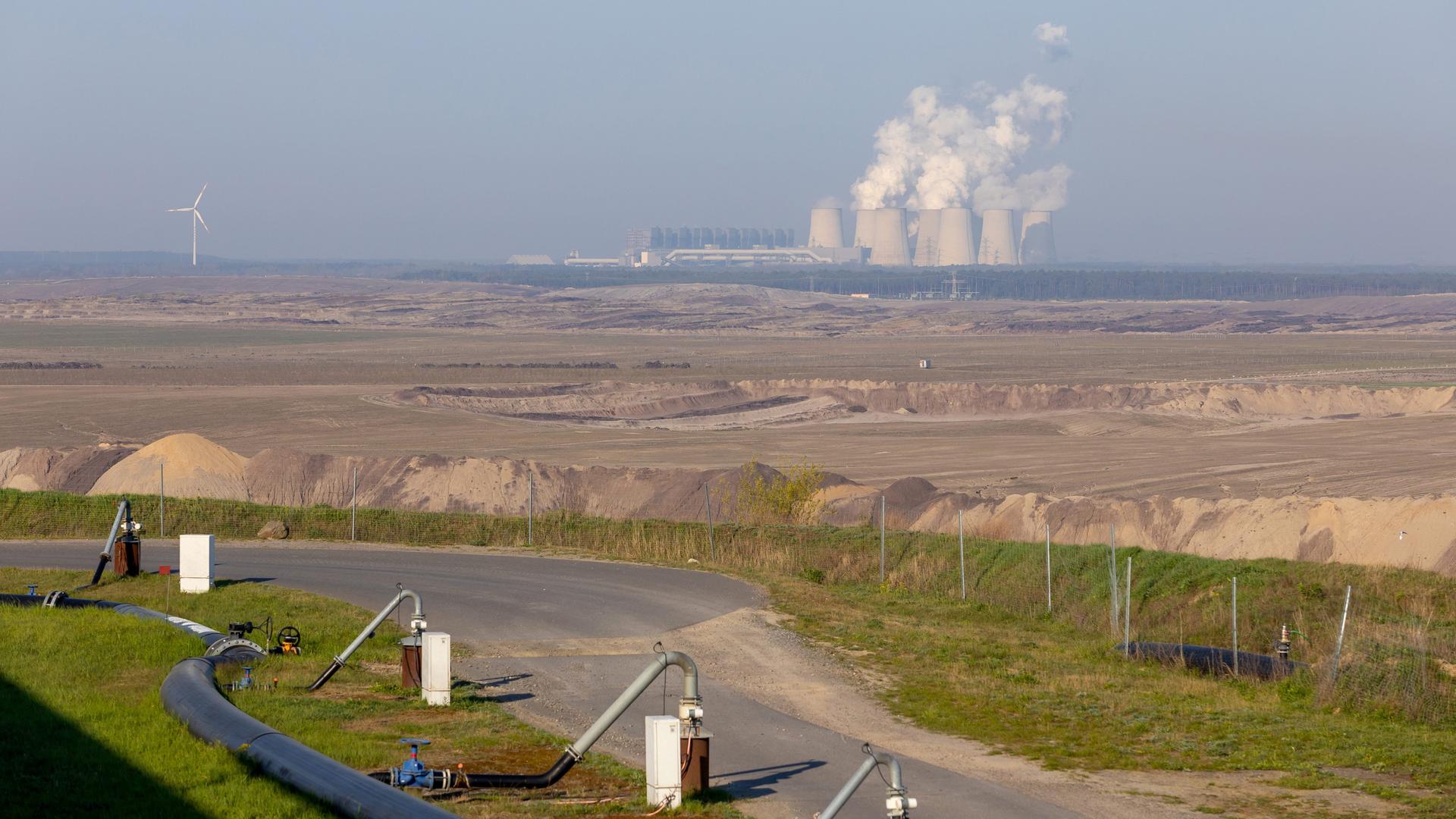 Blick über den Tagebau Jaenschwalde zu einem Kraftwerk, im Vordergrund sieht man Entwässerungsbrunnen. Blick über den Tagebau Jaenschwalde zu einem Kraftwerk, im Vordergrund sieht man Entwässerungsbrunnen.