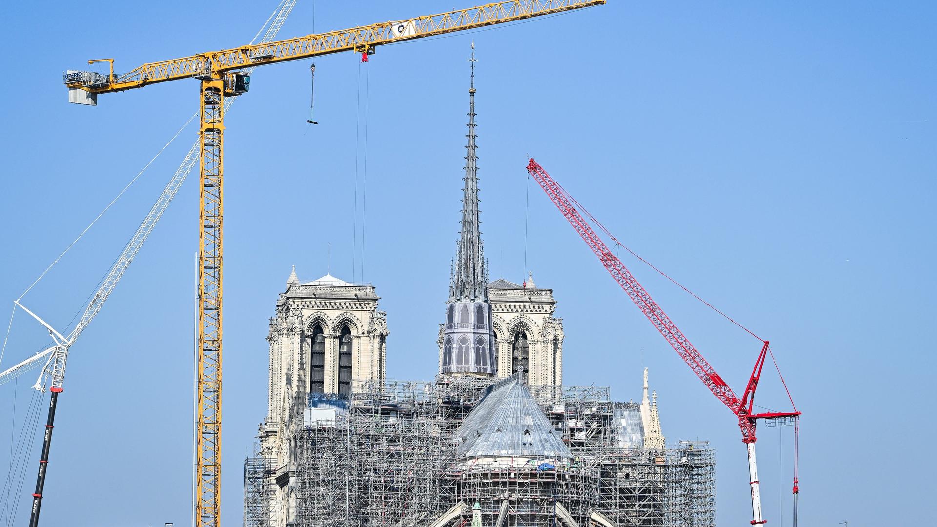 Blick auf die Baustelle Notre-Dame de Paris: In der Bildmitte ist die zum Teil eingerüstete Kathedrale zu sehen, links und rechts Baukräne.