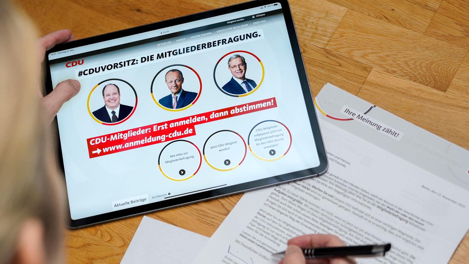 Die CDU-Mitgliederbefragung mit drei Kandidaten für den Parteivorsitz ist auf einem Tablet zu sehen.