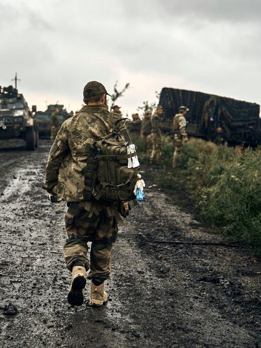 Ukraine, Charkiw: Ukrainische Soldaten stehen auf einer Landstraße in dem befreiten Gebiet in der Region Charkiw. 