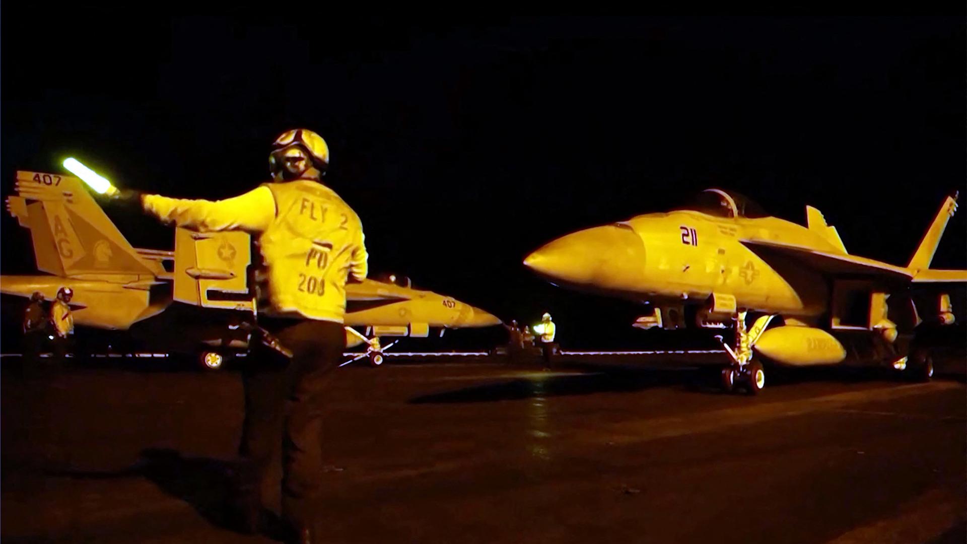 Ein Screenshot von Videomaterial des US-Zentralkommandos (CENTCOM) am 21. Juli 2026 zeigt einen sogenannten Marshaller des US-Militärs, der Kampfflugzeuge beim Start den Weg weist.