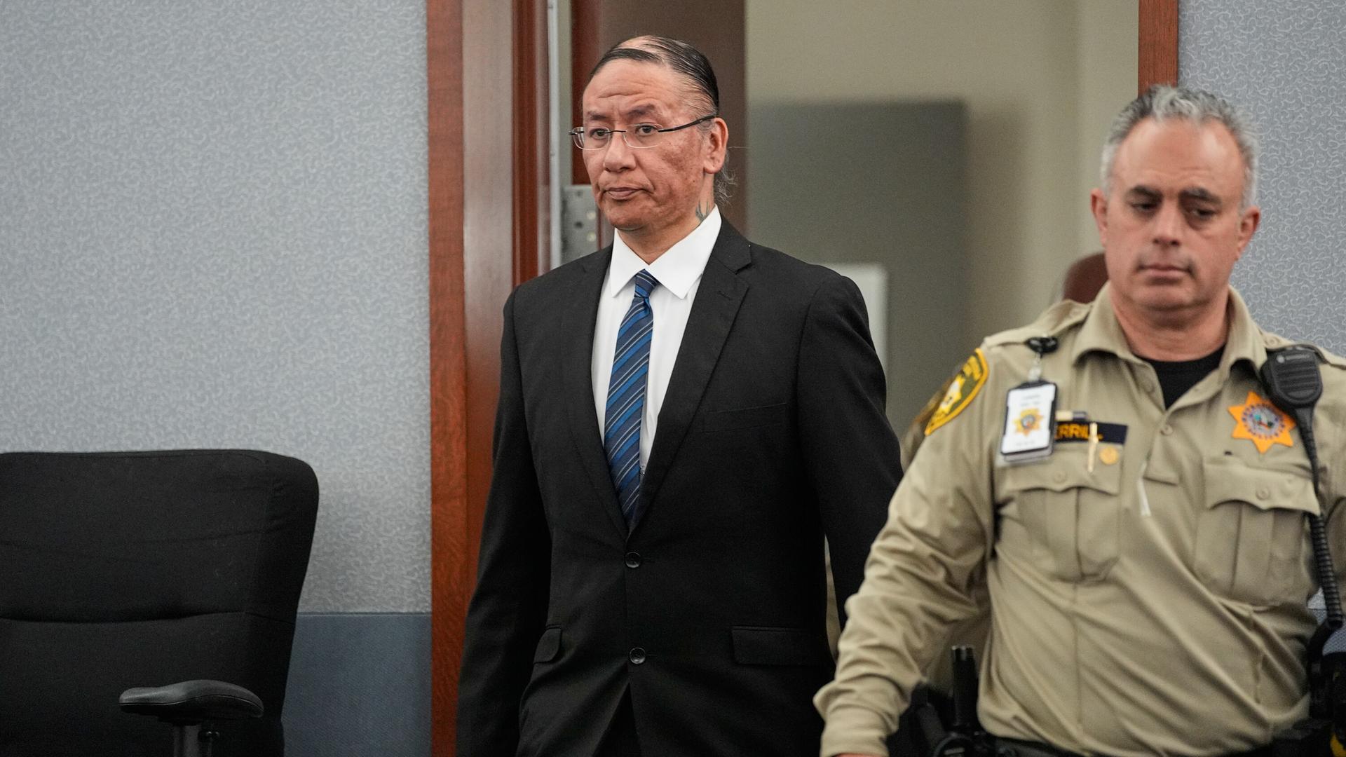Nathan Chasing Horse, center, walks back into the courtroom after a break in his trial on charges of sexually abusing Indigenous women and girls Tuesday, Jan. 20, 2026, in Las Vegas. (AP Photo/John Locher)